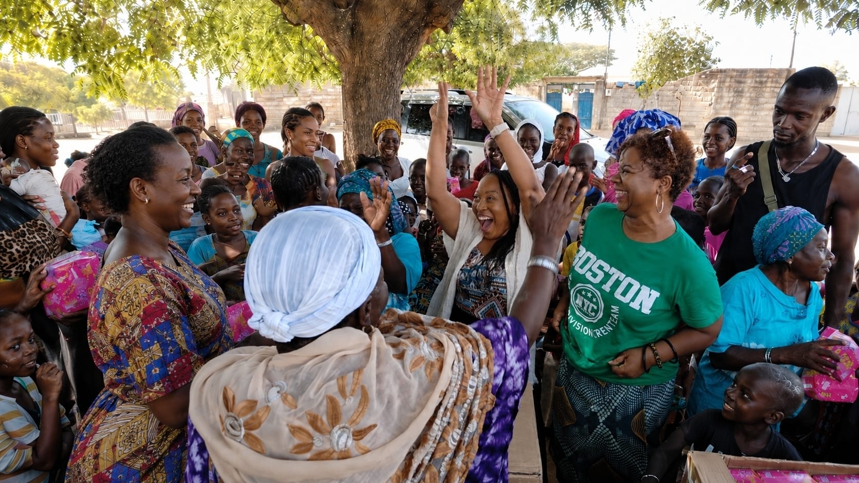 Gigi and women celebrating together during community outreach